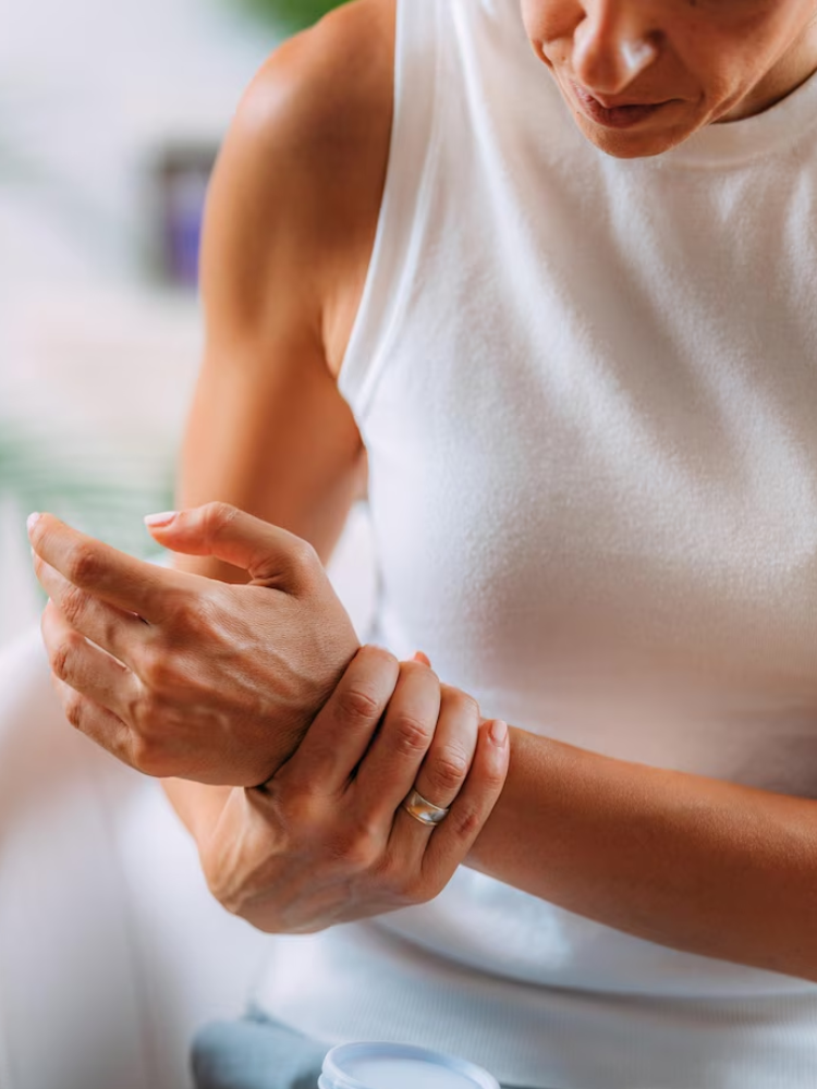 Close-up of a person holding their forearm