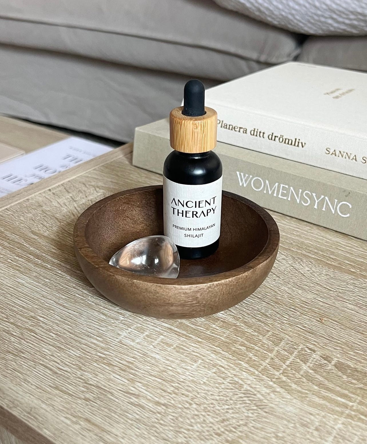 Ancient Therapy premium Shilajit Drops bottle with pipette in a wooden dish