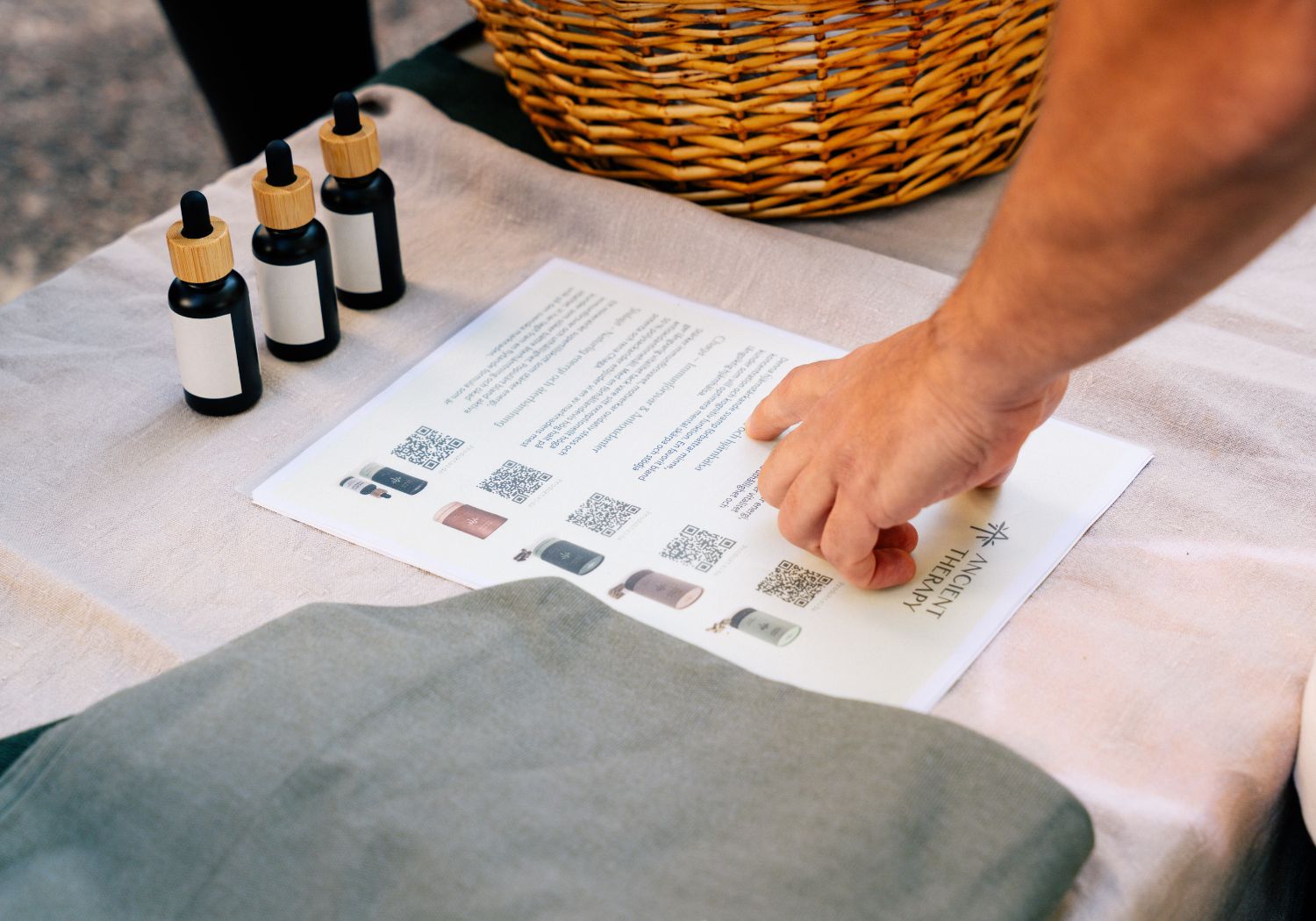 Person pointing on paper showing selections of ancient therapy products