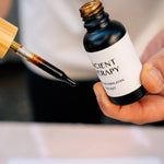 Hand holding Shilajit Drops with pipette