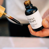 Hand holding Shilajit Drops with pipette