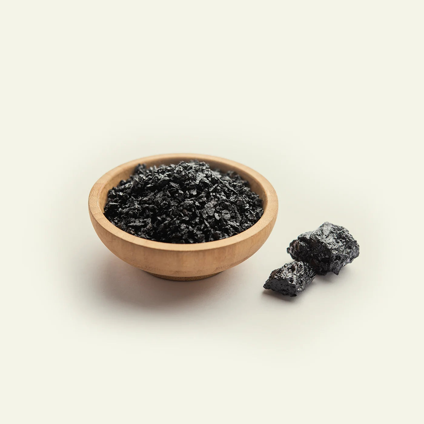 Mineral-rich shilajit resin in a wooden bowl